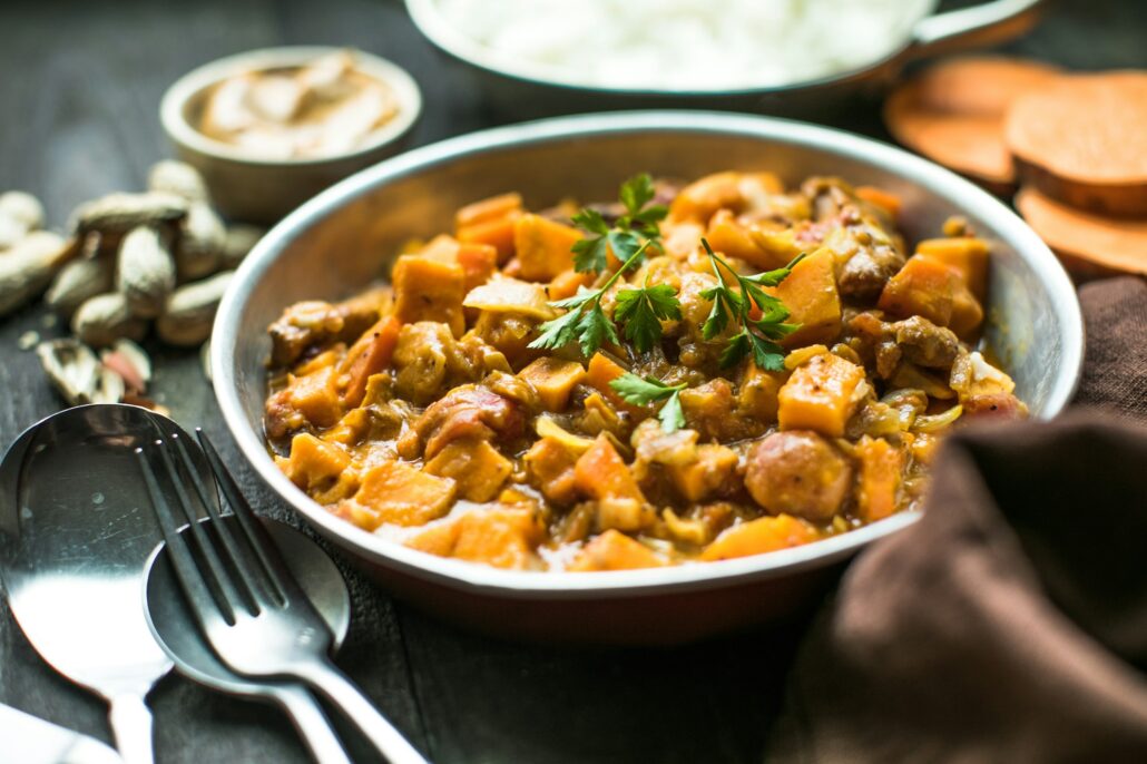 African chicken peanut stew with sweet potatoes with side of basmati rice
