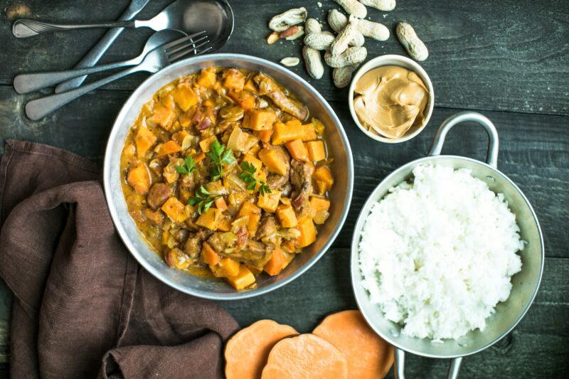 African chicken peanut stew with sweet potatoes with side of basmati rice