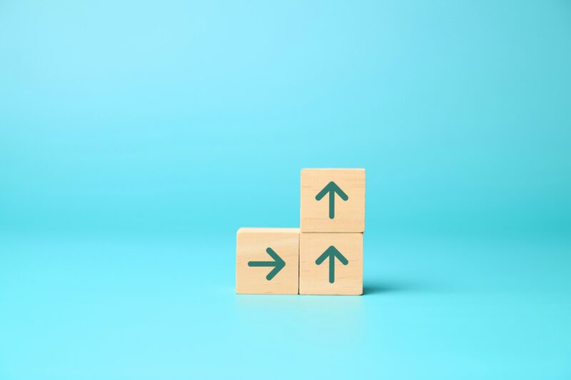 Arrow up icon on wooden blocks, Business growth success process, Business achievement goal and