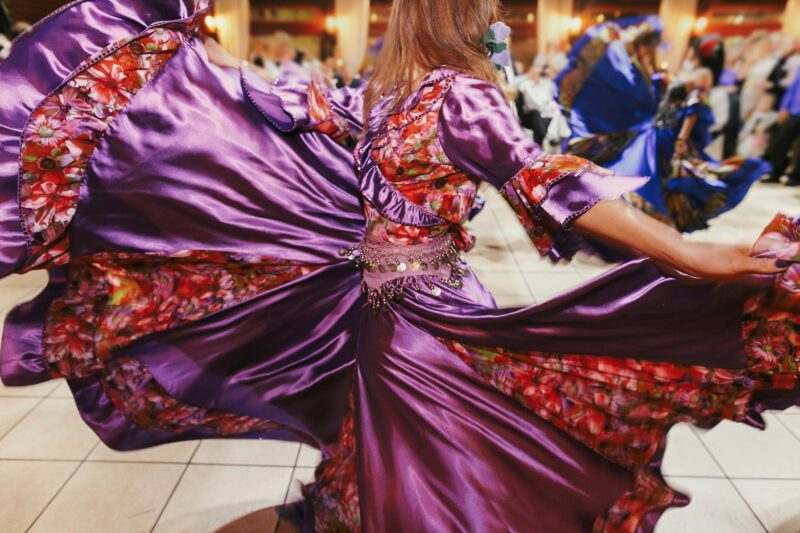 Beautiful gypsy girls dancing in traditional colorful clothing