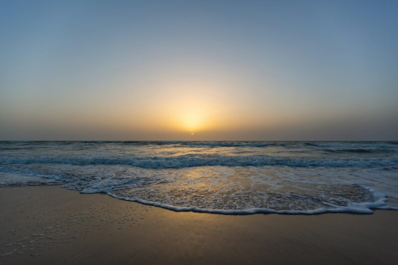 Beautiful picture of a sunset from a beach under a blue sky In Senegal