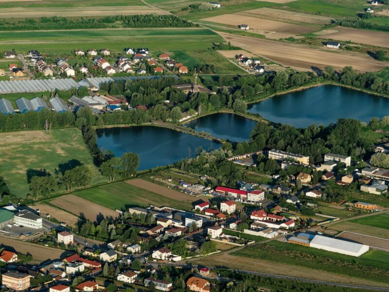Beautiful village lake and trees farming lands and houses aerial view