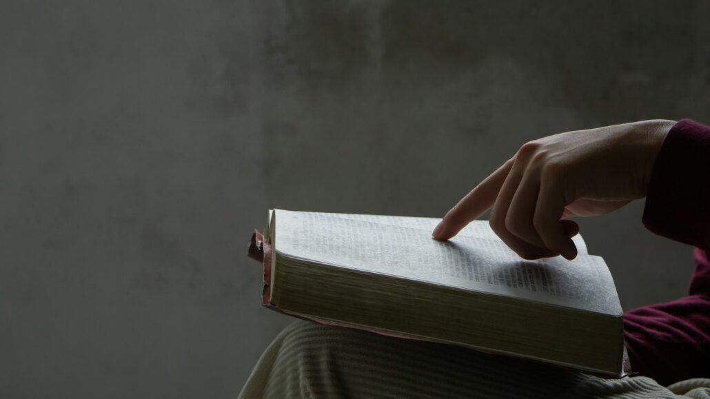 Bible concept.Man reading bible and praying to god before work. believe in goodness.