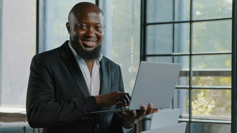 Businessman american african entrepreneur ceo analyst investor stand in modern skyscraper office