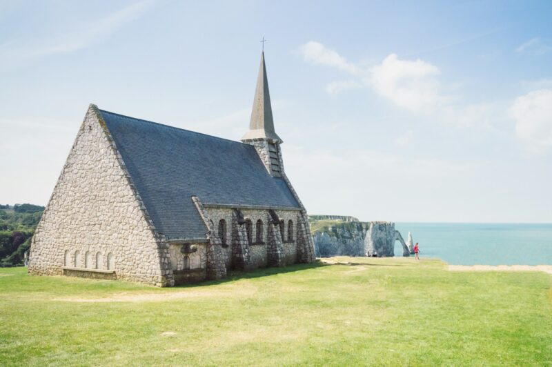 Christian chapel at the cliffs of Etretat in France in a blue sky summer day.