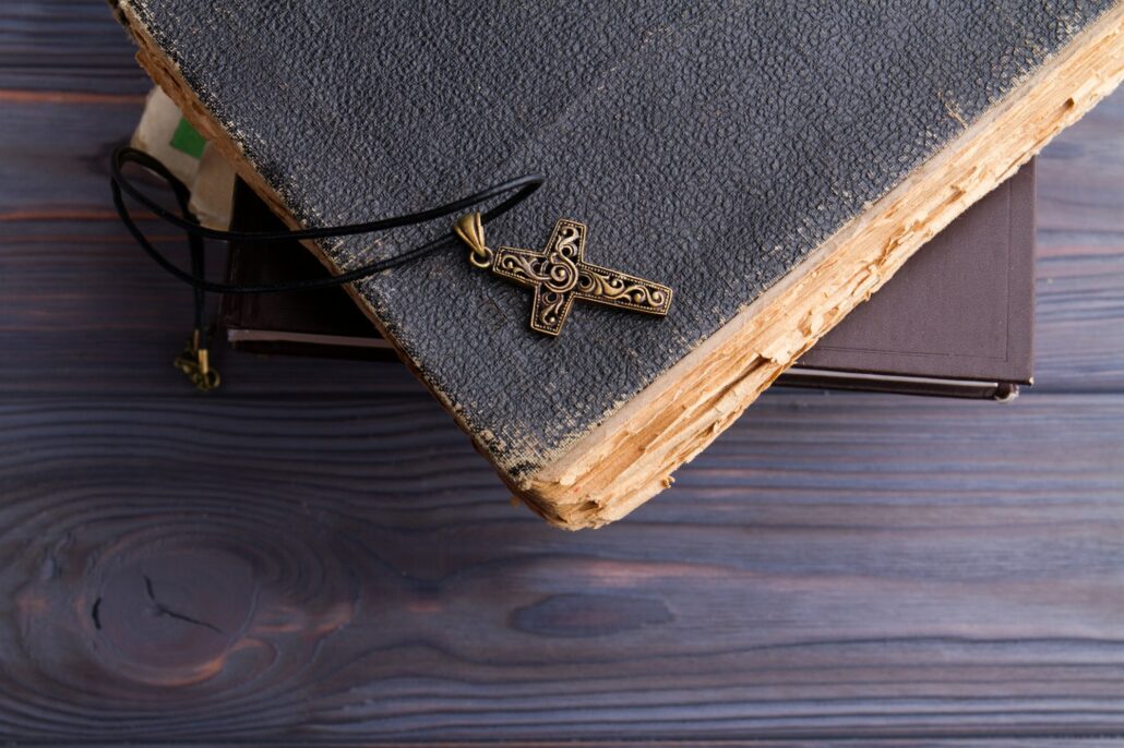 Christian cross on old aged coverbook.