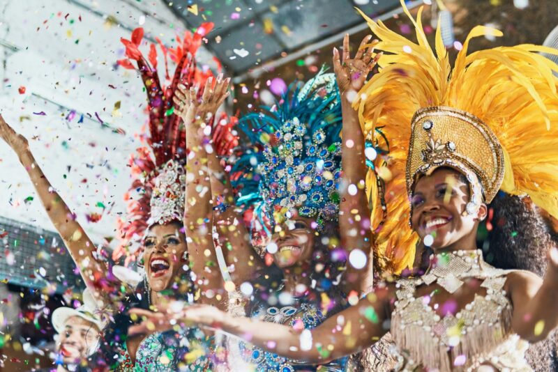 Cropped shot of beautiful samba dancers performing in a carnival with their band