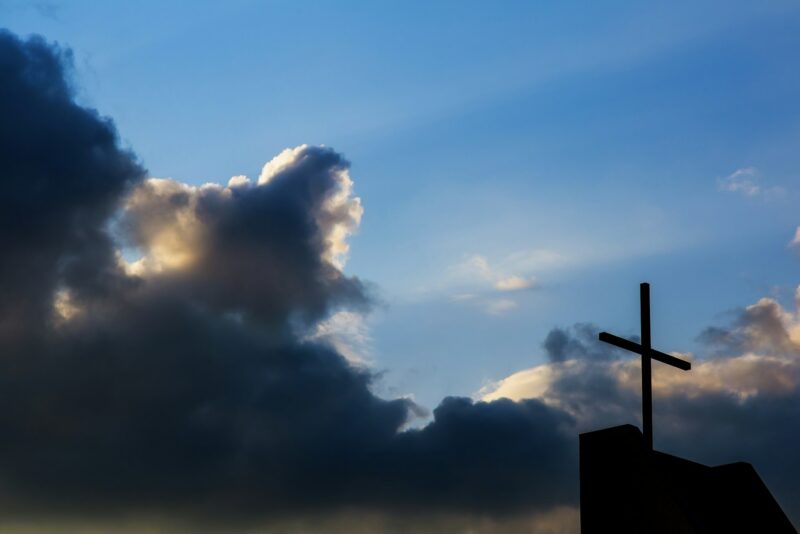 Cross against the sky background. religious christian cross with sunset concept