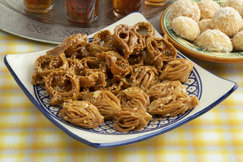 Dish with Moroccan festive homemade chebakia and coconut cookies