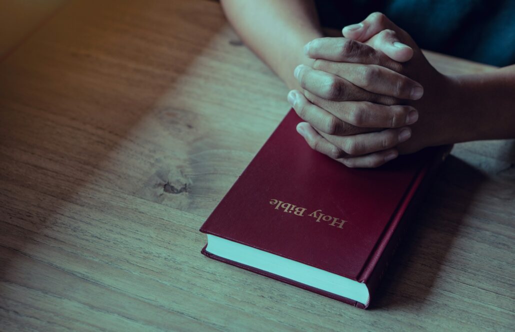 Hands of man with Bible praying.Christian life prayer to god. Man Pray for god.believe in goodness.