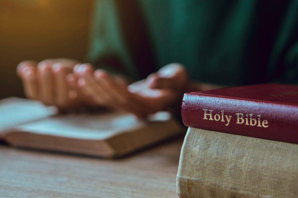 Hands of man with Bible praying.Christian life prayer to god. Man Pray for god.believe in goodness.