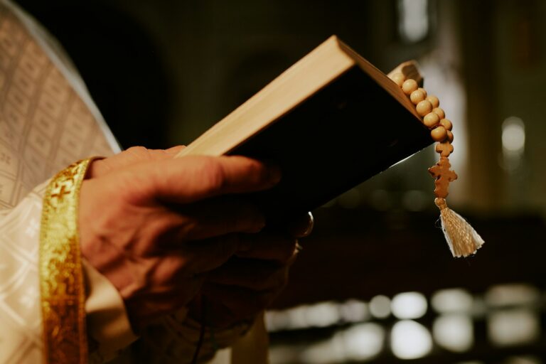 Hands Of Priest Holding Prayer Book