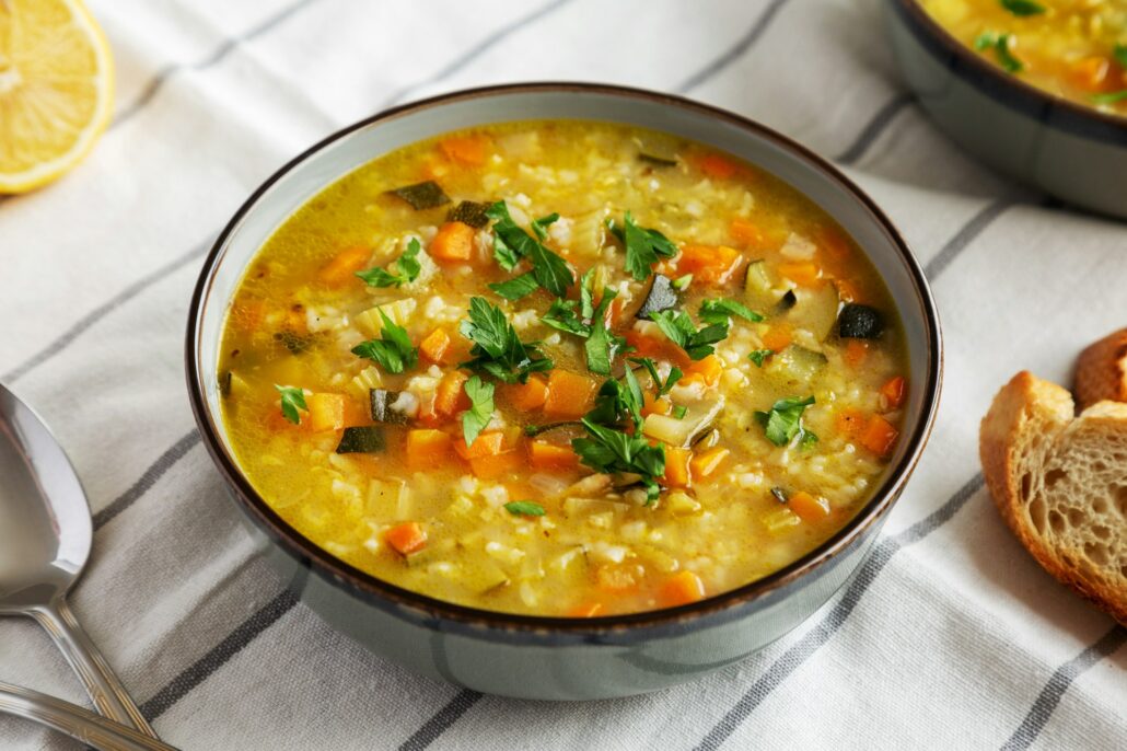 Homemade lemon rice soup in a bowl, side view.