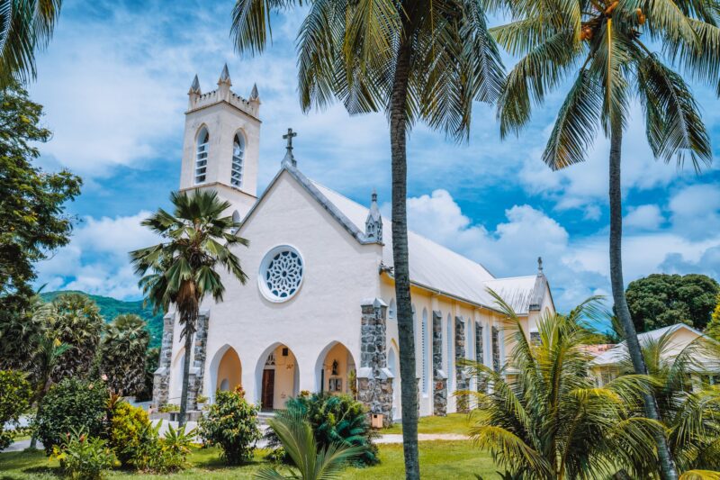 Mahe Island, Seychelles. St Roch Roman Catholic Church between palm trees near Beau Vallon location