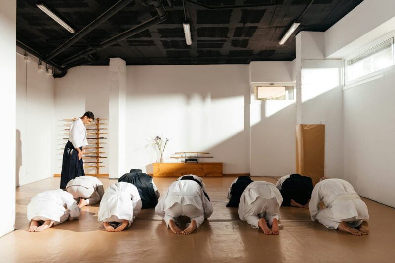 Martial Arts Students Performing Seiza Salute in Traditional Dojo Setting During Practice Session