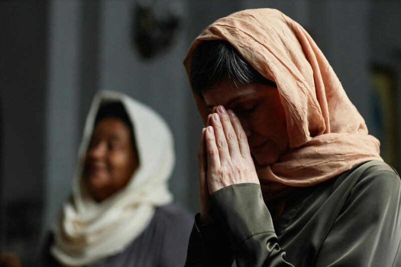 Mature woman praying in church