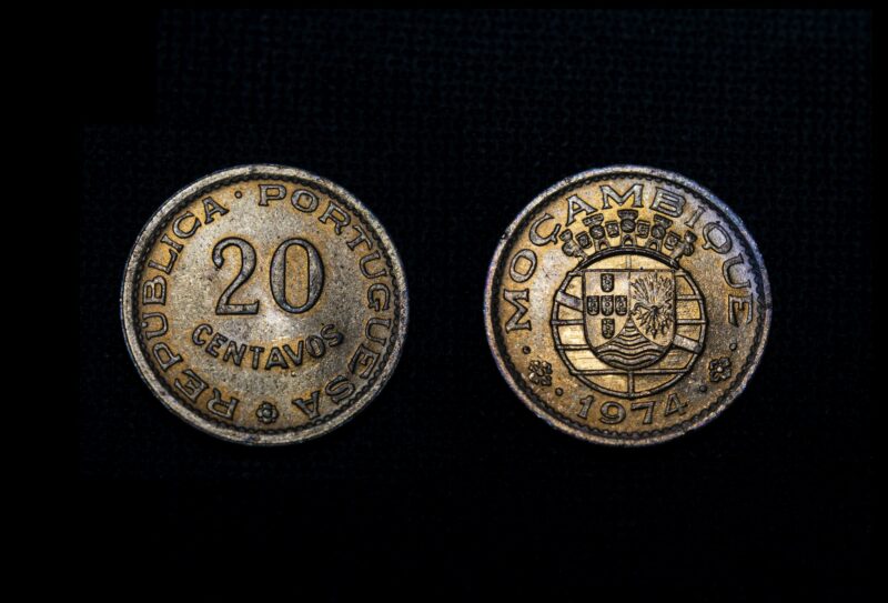 Mozambican escudo, centavos coin, old money of Mozambique on black background