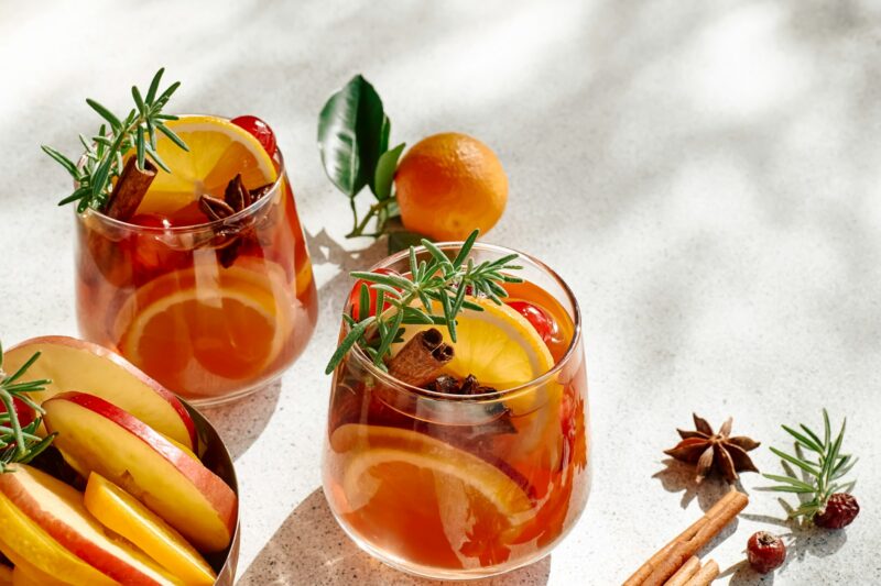 Mulled wine or christmas sangria with aromatic spices, apple, cherry and citrus fruits.