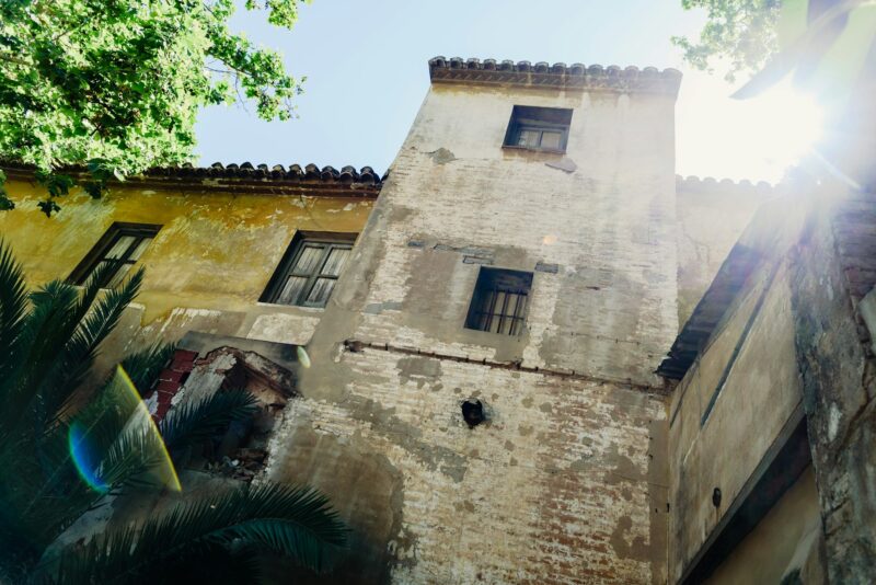 Old ruined mansion in Italian style with glimpses of the sun.