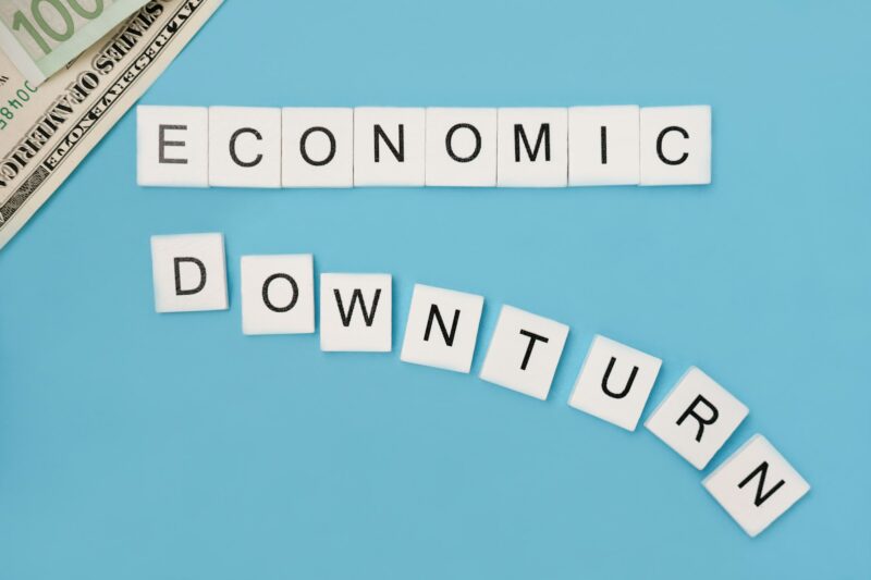 Phrase economic downturn spelled out in wooden letter tiles