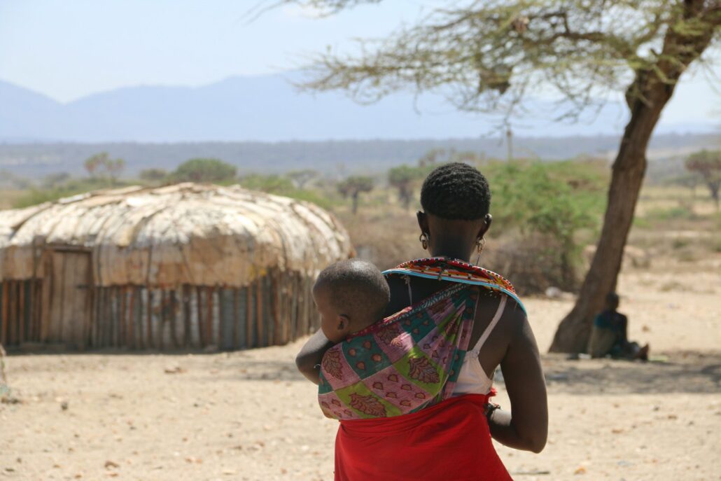 a woman carrying a child on her back