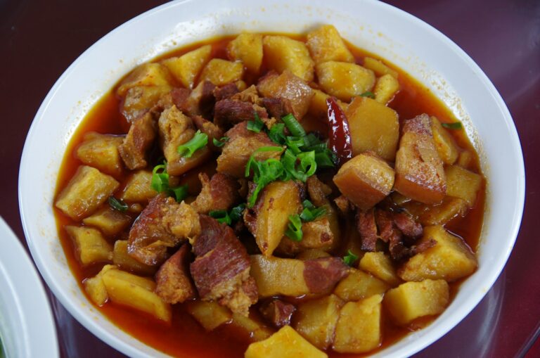 a white bowl filled with food on top of a table