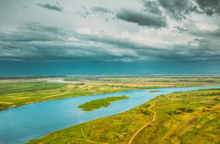 Rechytsa, Gomel Region, Belarus. Aerial View Of Dnieper River. Sky Above Green Meadow And River