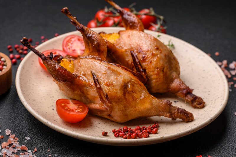 Roasted quail, partridge or pigeon stuffed with orange with spices and herbs