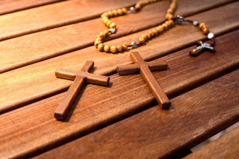 Rosary with wooden beads and Christian cross.