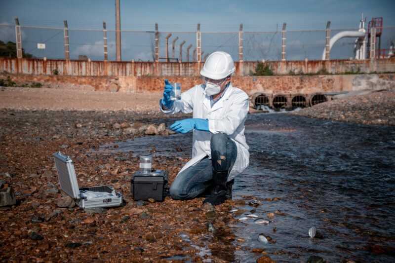 Scientist wearing protective uniform and glove under working water analysis and water quality by get