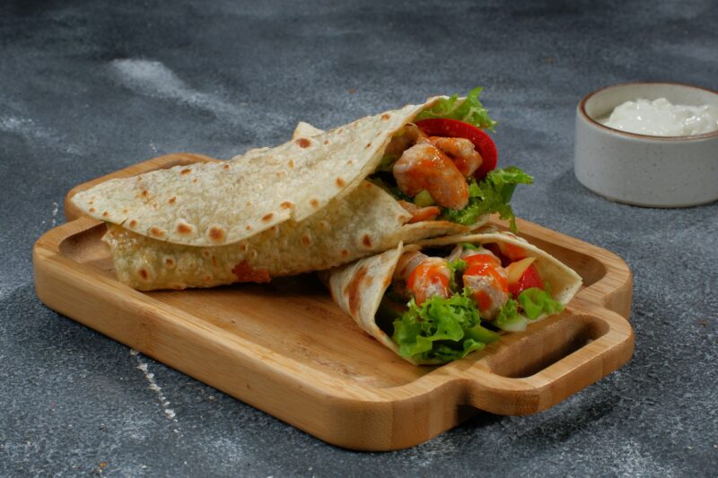 Shawarma chicken roll in a pita with fresh vegetables