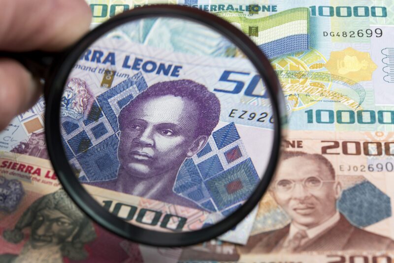 Sierra Leonean money in a magnifying glass