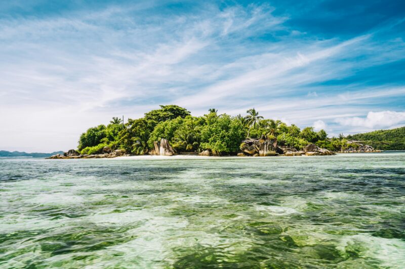 Small island in shallow island at Port Glaud lagoon, Mahe island, Seychelles
