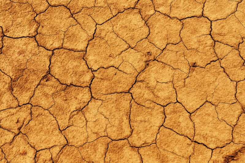Top view texture of dry soil, mud crack ground as background for climate change concept