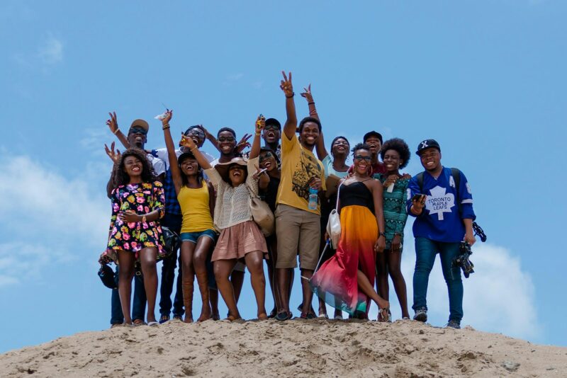 group of people standing on brown sand during daytime