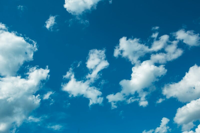 White cumulus clouds in a blue sky. Backgrounds with a pattern of high-beam clouds