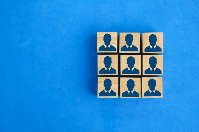 wooden cube and worker icon in square arrangement. The concept of human resources.