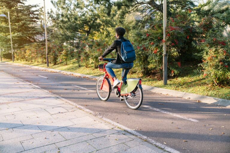 young man a moroccan student riding a shared electric bike in a beautiful park